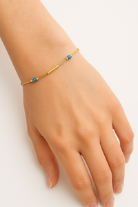 Pulsera con tubos lisos de oro 10k y ojitos turcos medida para dama